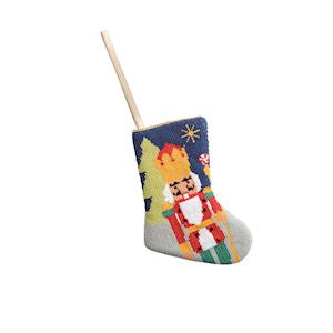 Decorative Christmas stocking with a nutcracker design on a white background