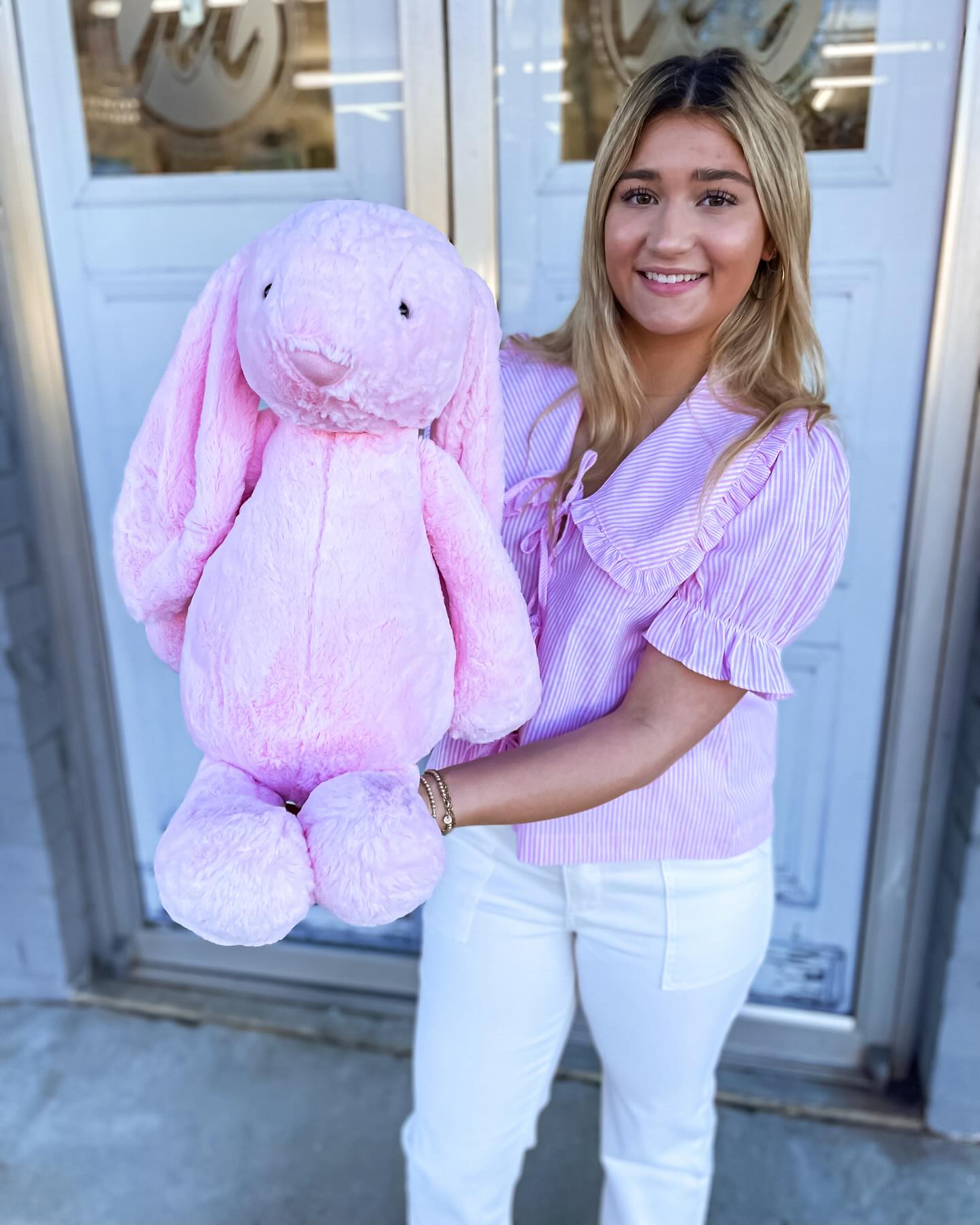 A large floppy ear bunny stuffed animal in pink.