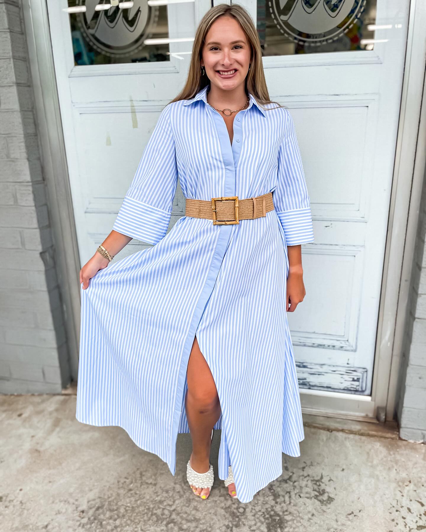 A collar neckline button down design with half sleeves with a striped pattern of blue and white while has a loose relaxed fit.