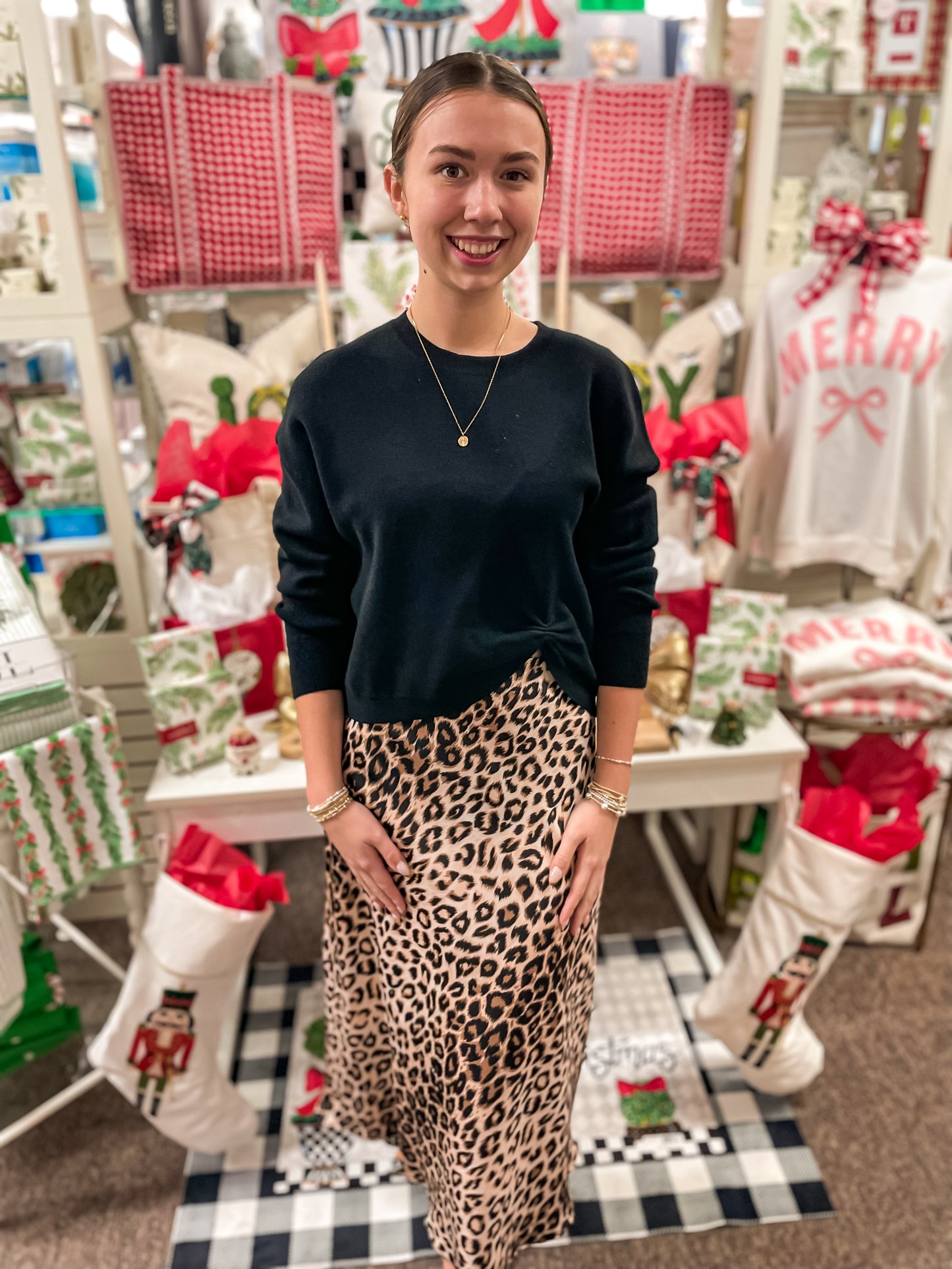 Woman standing in a store with Christmas-themed decor