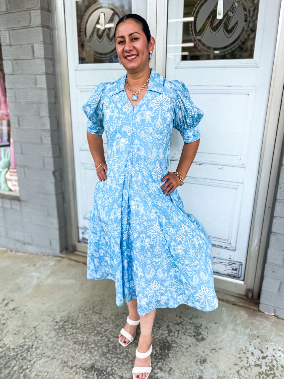 A light blue dress with an elephant and palm tree print