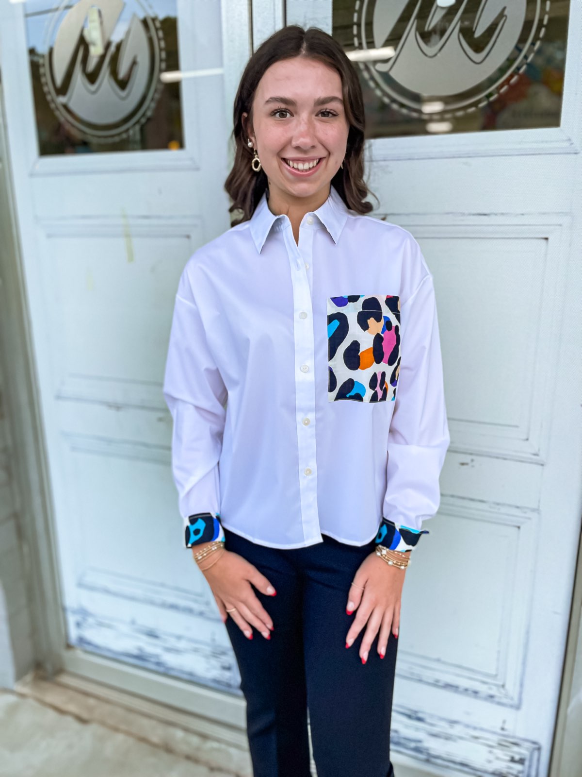 Marina boxy, relaxed fit shorter length long sleeve button down top. With an oversized pocket with multicolor leopard design.