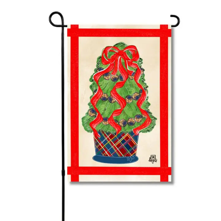 Christmas garden flag featuring a festive topiary tree decorated with red ribbon, pinecones, and greenery, topped with a large red bow and displayed in a red plaid planter.