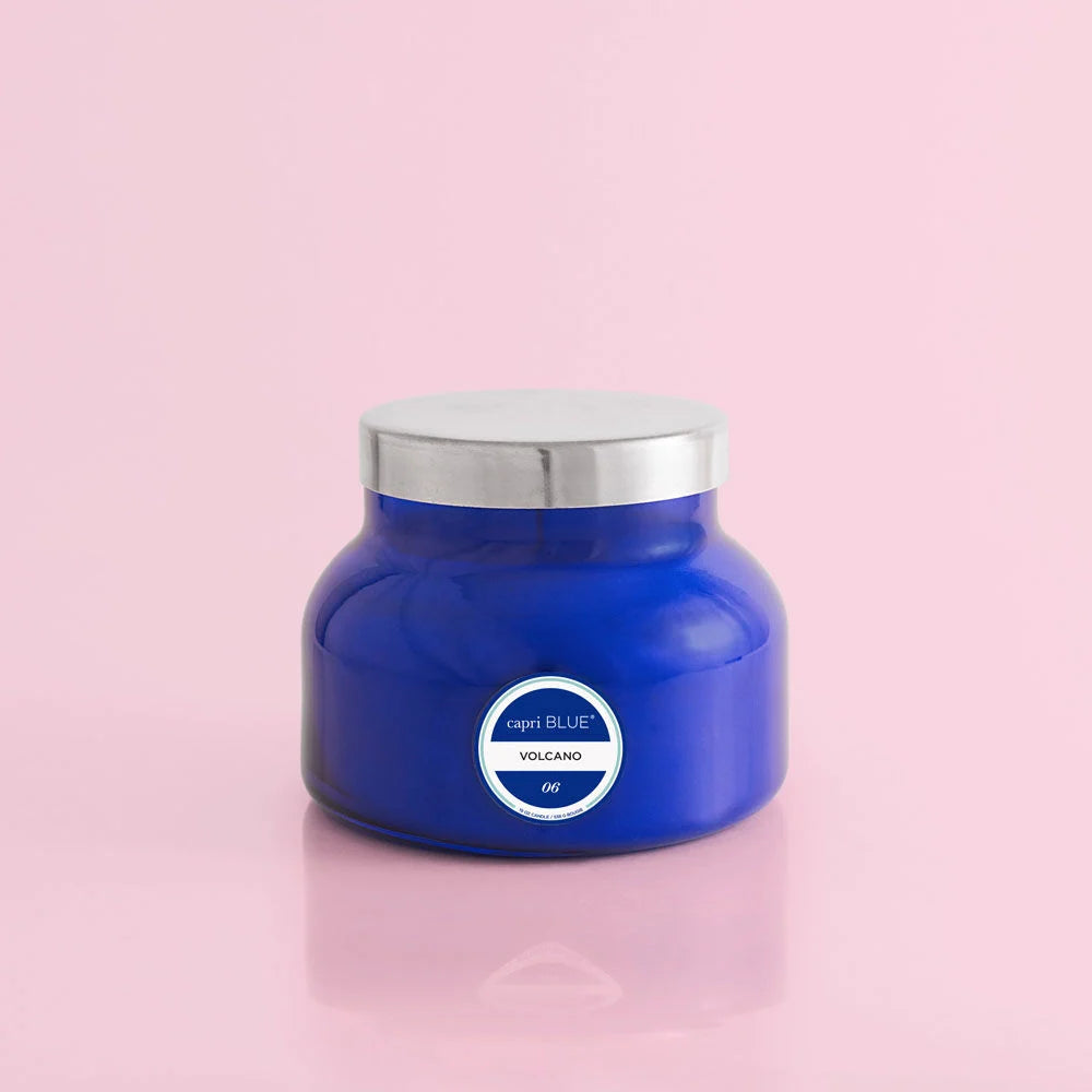 Blue round candle, volcano scent, with silver top..