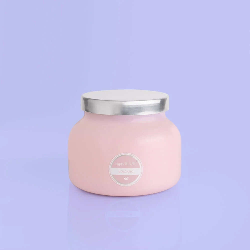Light pink round candle, volcano scent, with silver top..