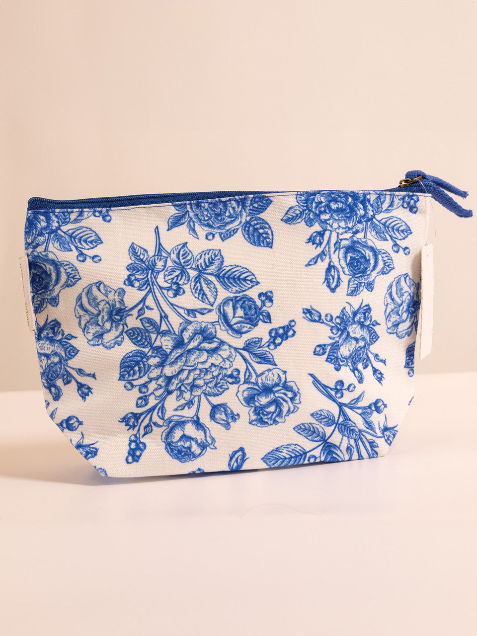 A cosmetic pouch with a blue and white floral pattern.