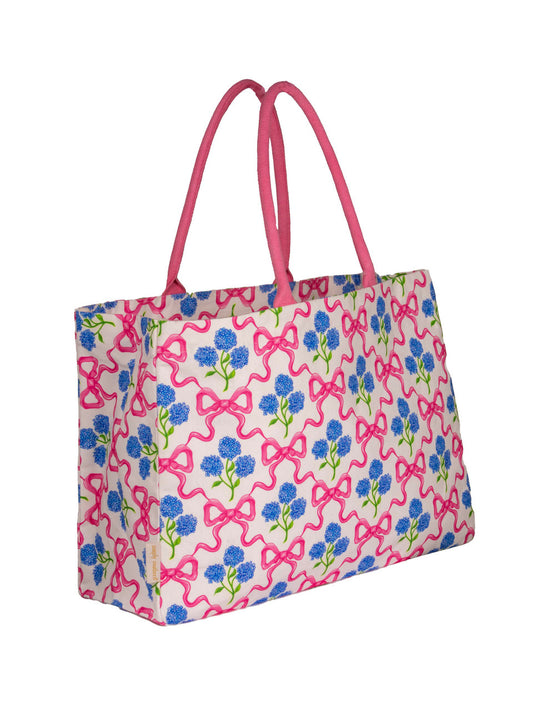 A large canvas tote with a bow and floral pattern. 