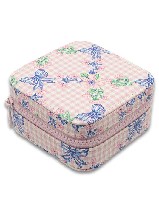 Small rectangular jewelry box with a pink checkered pattern and blue bows on a white background