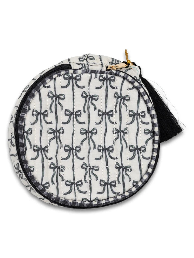 Circular pouch with black bow pattern on a white background