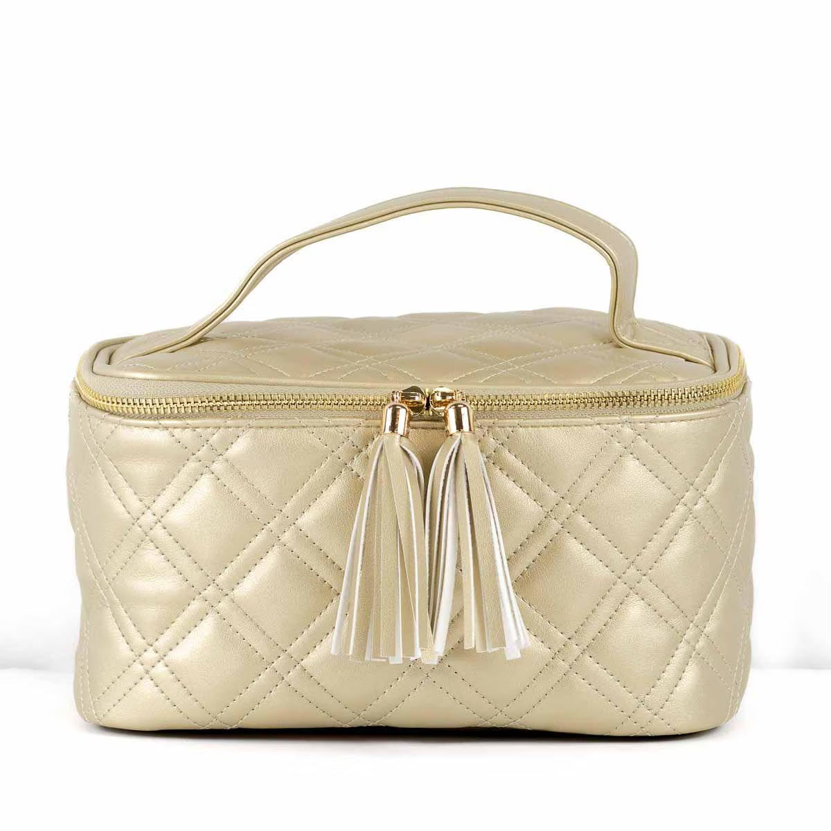 A quilted metallic champagne-gold cosmetic bag with a top handle, gold zipper, and two white tassels, shown on a plain white background.