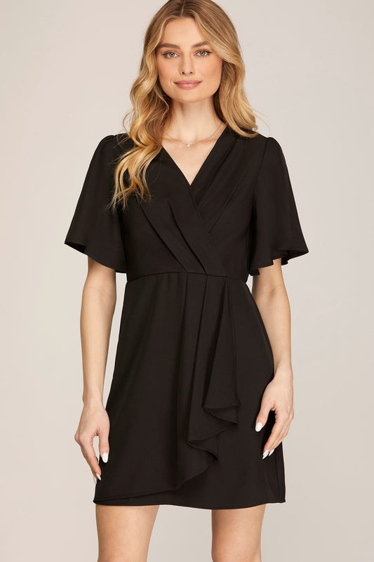 A black dress with a ruffled wrap design and short sleeves