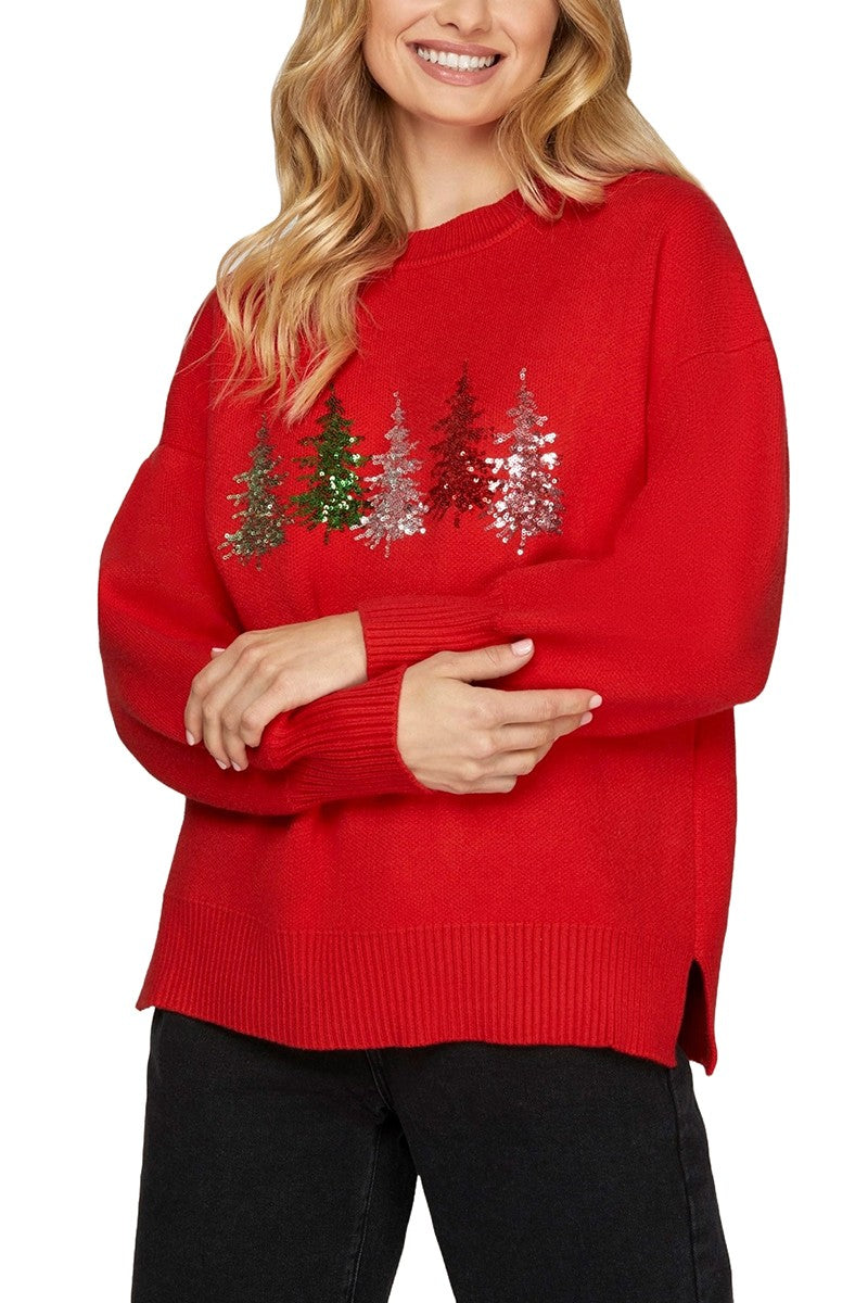 A red sweater with five different color sequin Christmas trees in the center.