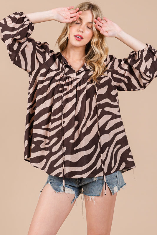 Two shades of brown zebra printed top. With a flattering V-neck with a self-tie, this blouse top also has shirring detail and balloon sleeves with elastic cuffs. 