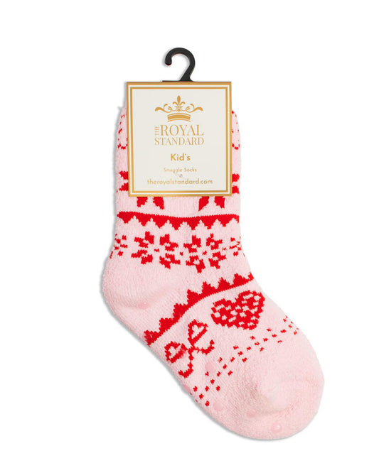 A single light pink knit sock with a red Fair Isle pattern, hanging from a black hanger with a cream paper label that reads Royal Standard Kid's Straight Forward.