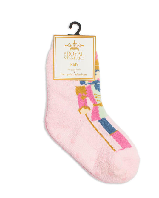 A single pink fuzzy sock for kids with a colorful nutcracker graphic, hanging from a black hanger with a Royal Standard brand tag.
