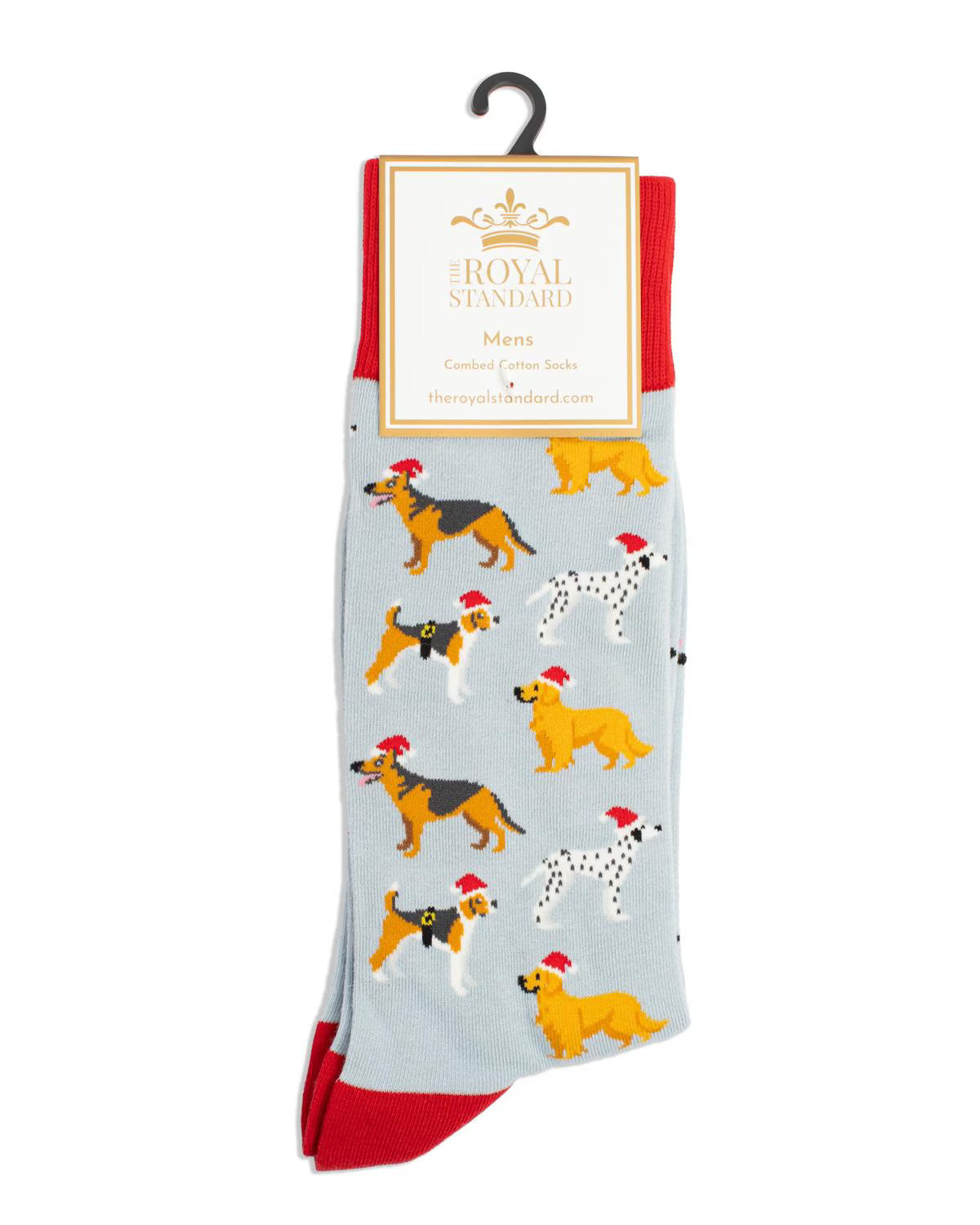 A pair of light blue socks with red heels and toes, featuring a playful pattern of various dog breeds wearing red Santa hats. The socks are packaged on a black hanger with a white paper header card that reads 'The Royal Standard'.