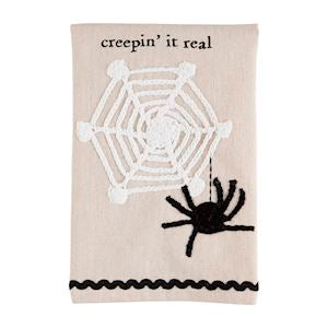 A Halloween crochet tea towel with black spider and spider web with the words "creepin' it real" with black rickrack trim