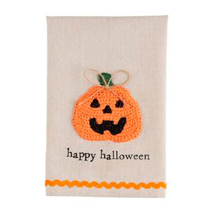 A Halloween crochet tea towel with a jack-o’-lantern with the words "happy halloween" with orange rickrack trim