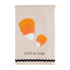 A Halloween crochet tea towel with candy corn and the words "treat or treat" with black rickrack trim