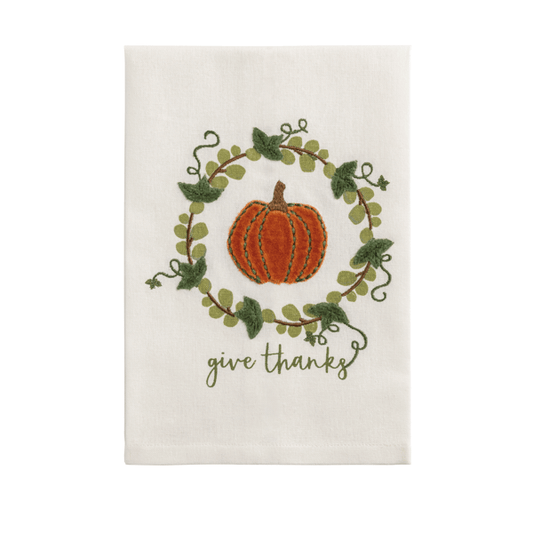 Decorative towel with a pumpkin and 'give thanks' text on a white background