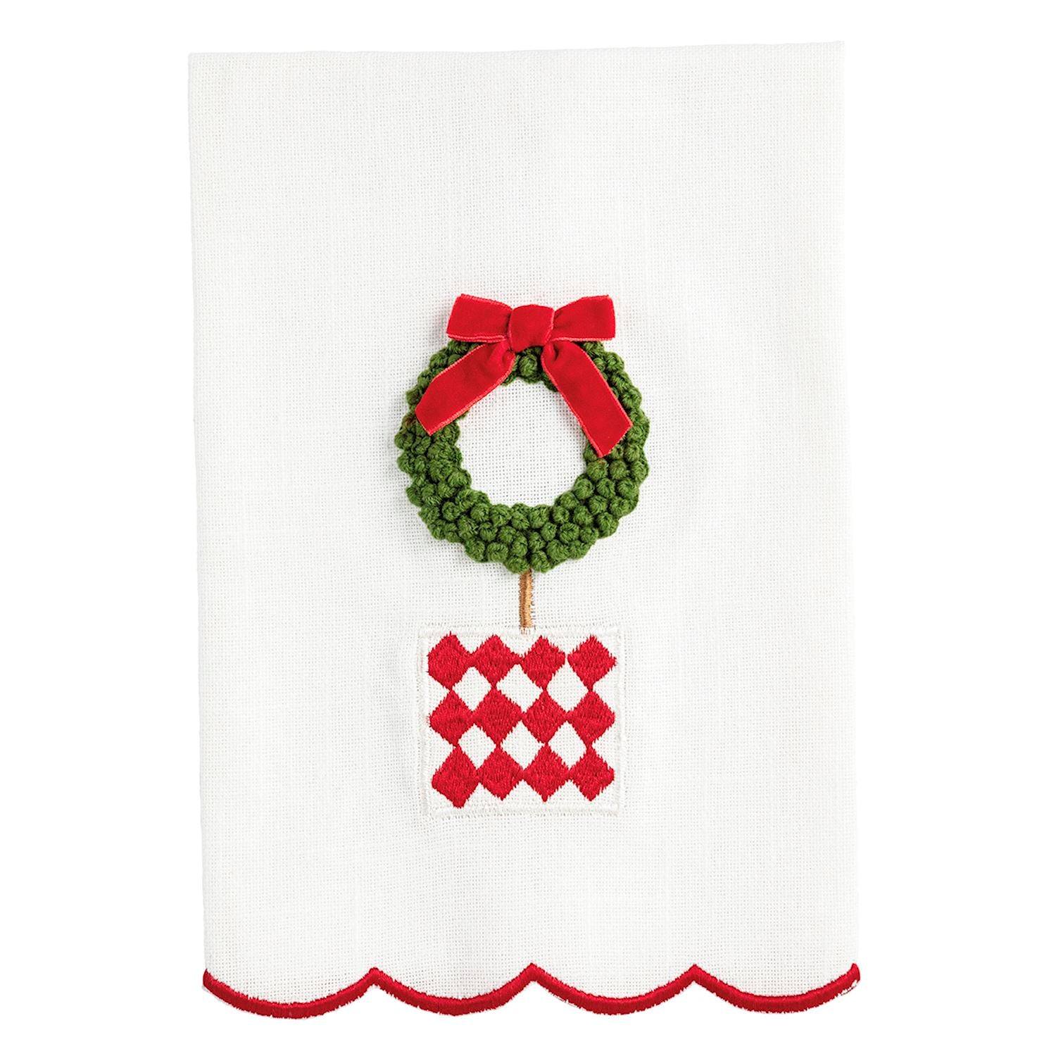 Decorative towel with a green wreath and red bow on a white background