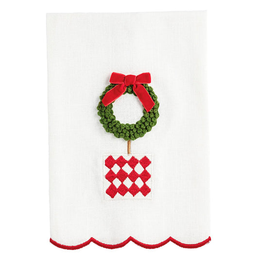 Decorative towel with a green wreath and red bow on a white background