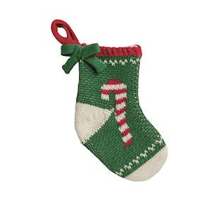 A small hand-knit Christmas stocking ornament in green and cream with a red and white candy cane motif, featuring a red hanging loop and green bow.