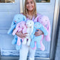 A large and medium floppy ear bunny stuffed animal in blue and pink.