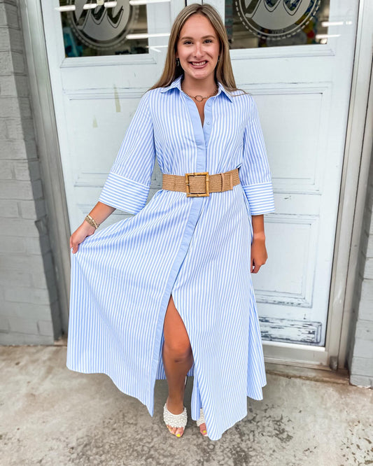 A collar neckline button down design with half sleeves with a striped pattern of blue and white while has a loose relaxed fit.