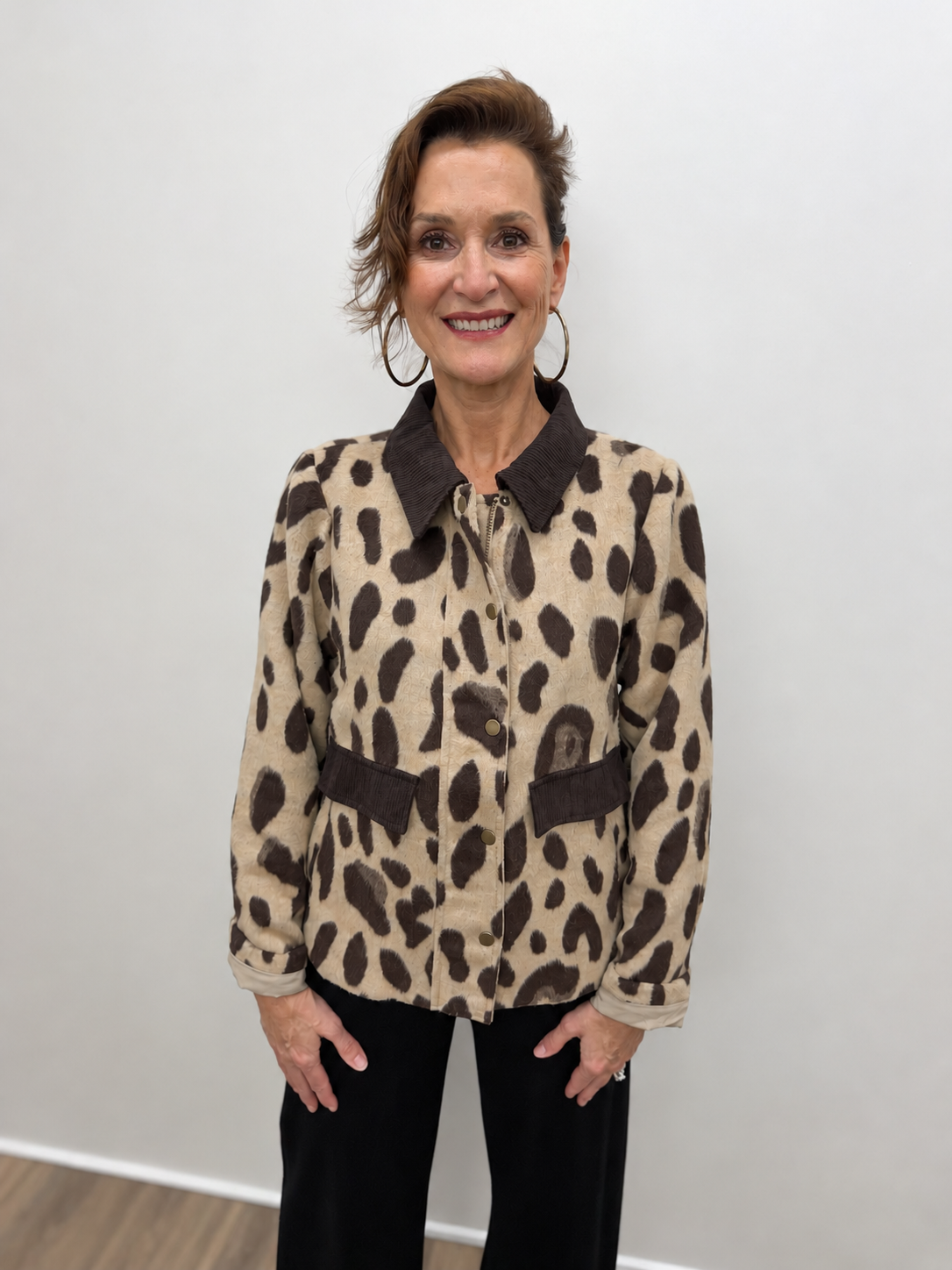 Women’s beige and dark brown leopard print jacket featuring a contrasting brown collar, snap-button front, long sleeves, and front flap pockets.