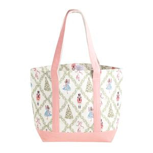 A tote bag with a cream and pink patterned body featuring a repeating trellis design with small illustrated figures and trees, finished with solid pink handles and base.