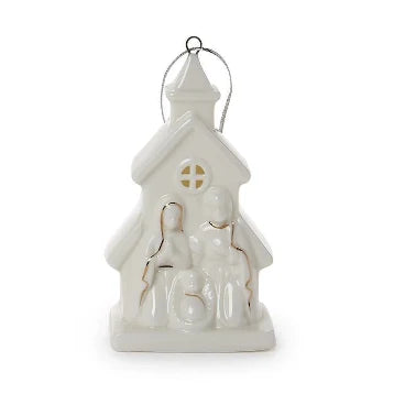 White ceramic church-shaped nativity ornament featuring Mary, Joseph, and baby Jesus, accented with subtle gold details and a silver hanging loop.