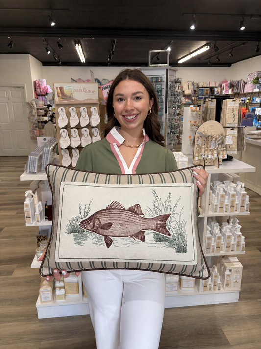 This decorative rectangular fish pillow features a detailed, vintage-inspired fish illustration surrounded by delicate aquatic grasses and water accents. The cream center panel is framed by a neutral striped border in beige, taupe, and muted green, giving it a classic outdoorsy look. Finished with dark brown piping around the edges, this pillow is perfect for adding a rustic, lodge-inspired touch to a living room, lake house, cabin, or den.