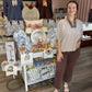 This is a cream and chocolate-brown striped blouse with a relaxed, easy silhouette. It features a V-neckline with a contrasting leopard-print inset and collar detail, adding a fun mixed-print element. The short puff-style sleeves have soft gathering for a feminine touch, while the loose fit gives it an effortless, comfortable feel.