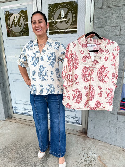 Shyann top with smocking detail with 3/4 length sleeves with a paisley print in red mix.