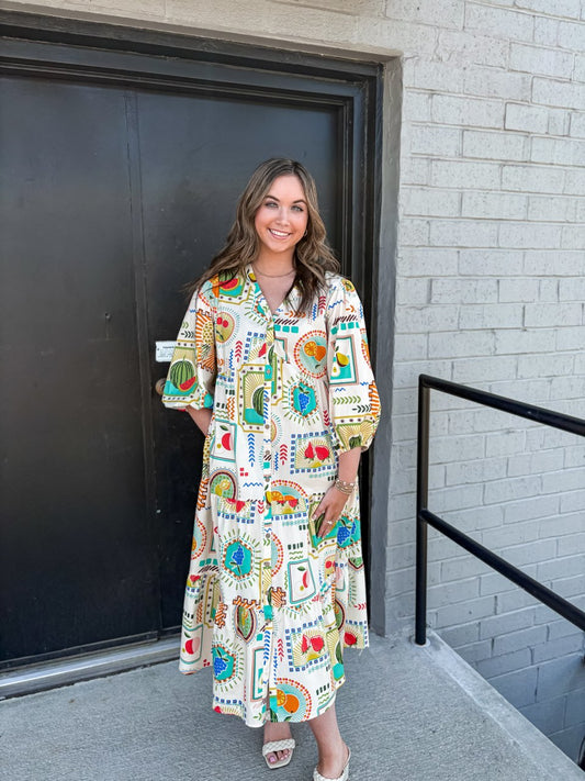 Alaia dress with 3/4 puff sleeves and cinched ends. A v-neck with button down closure and tiered and ruffled bottom in banana milk design.