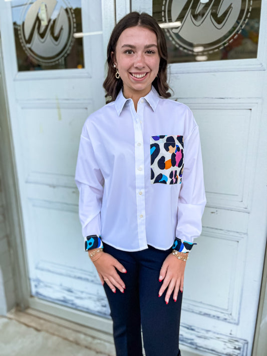 Marina boxy, relaxed fit shorter length long sleeve button down top. With an oversized pocket with multicolor leopard design.