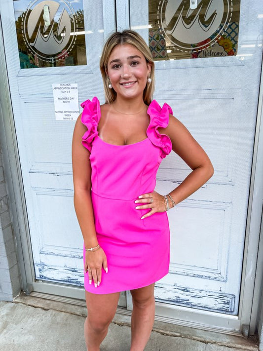 A hot pink dress with a scoop neckline and delicate ruffles. 