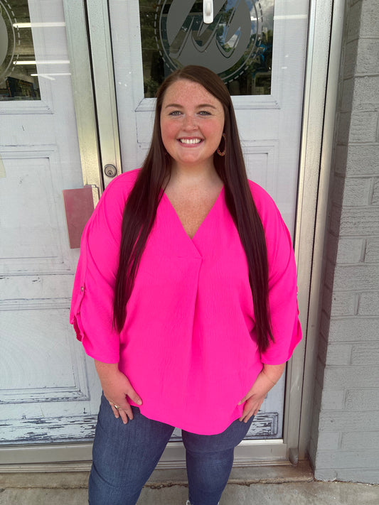 Quarter length sleeve, V-neck top in neon pink. 