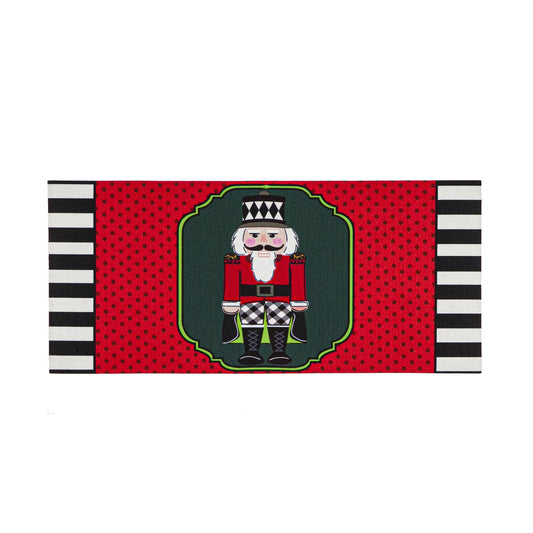 Red floor mat with black polka dots and a nutcracker in the center.