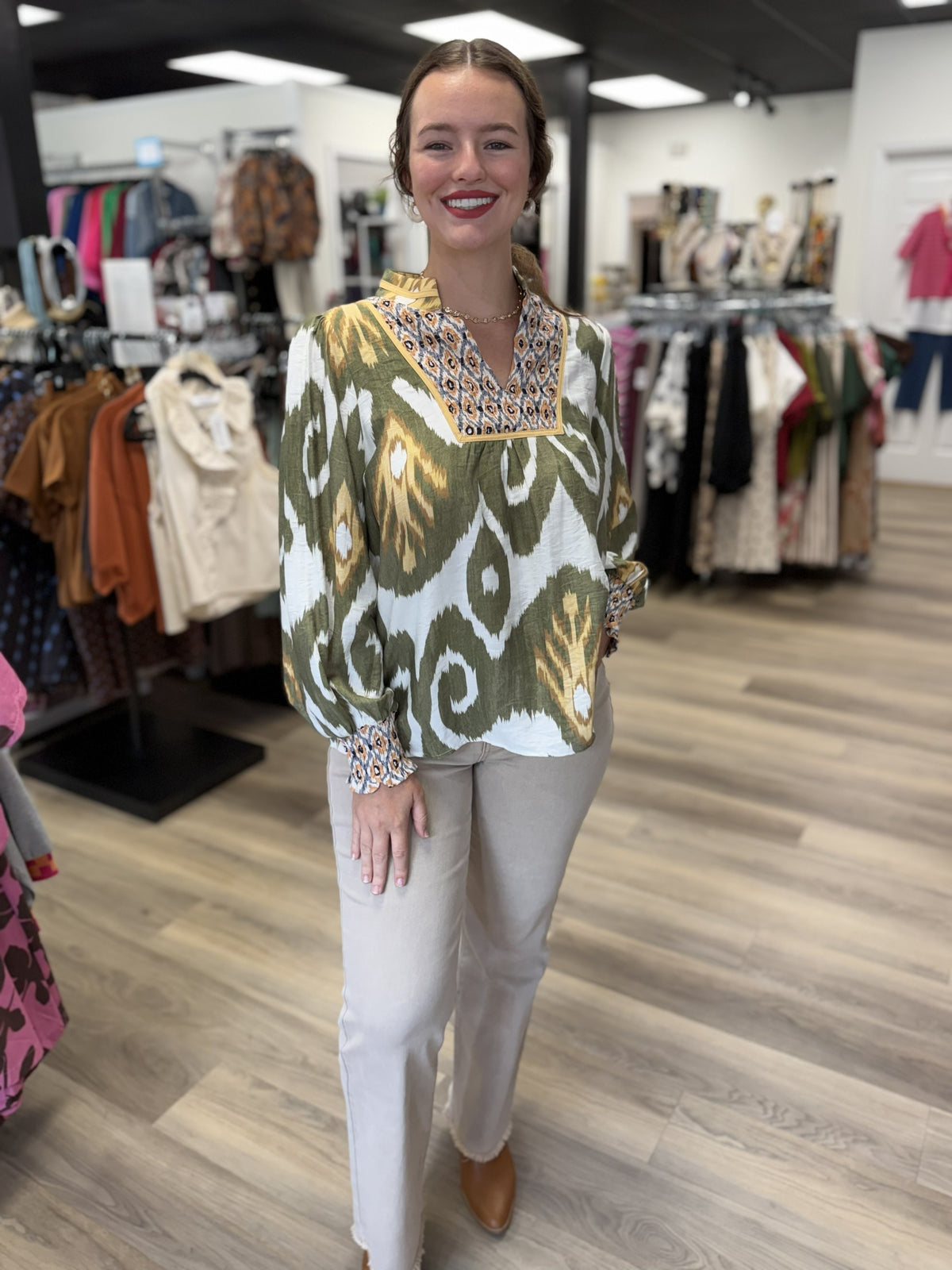 These pants are light taupe straight-leg pants with a clean, streamlined silhouette. They feature a mid-rise fit, smooth front, and a relaxed straight cut through the leg. The ankle-length hem has a subtle raw/frayed finish, adding a casual touch to the polished neutral style.