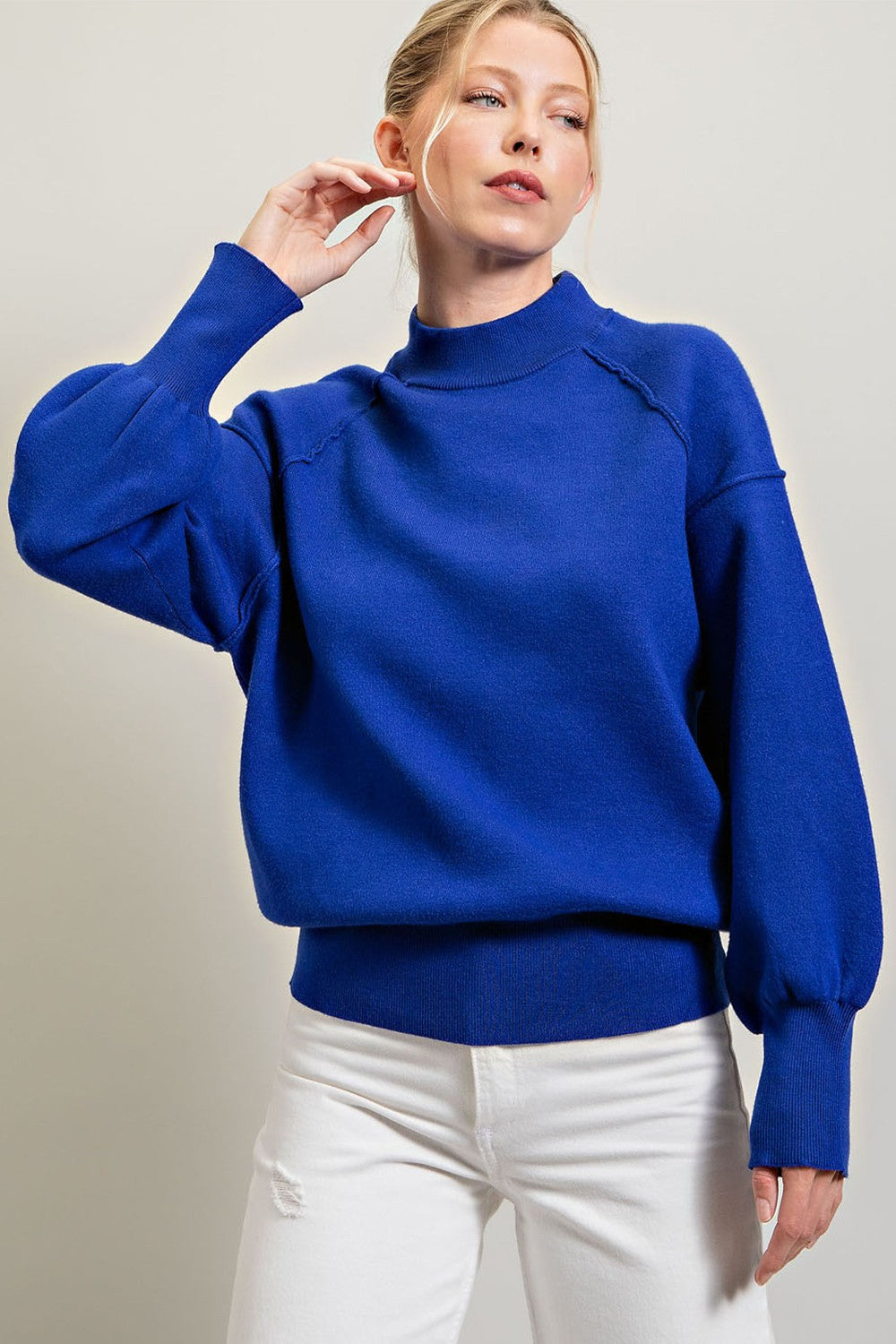 Blue Solid long sleeve sweater featuring gauntlet cuffs to create a bubble sleeve effect, added seams for detail, a crew neckline, and a ribbed bottom band and neck.