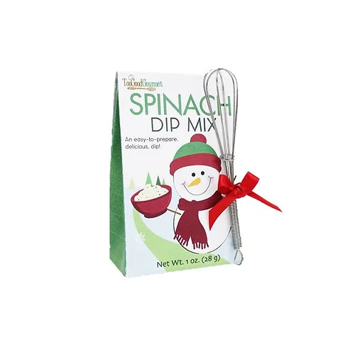 Spinach dip mix in a festive illustrated box, accompanied by a small metal whisk tied with a green ribbon.