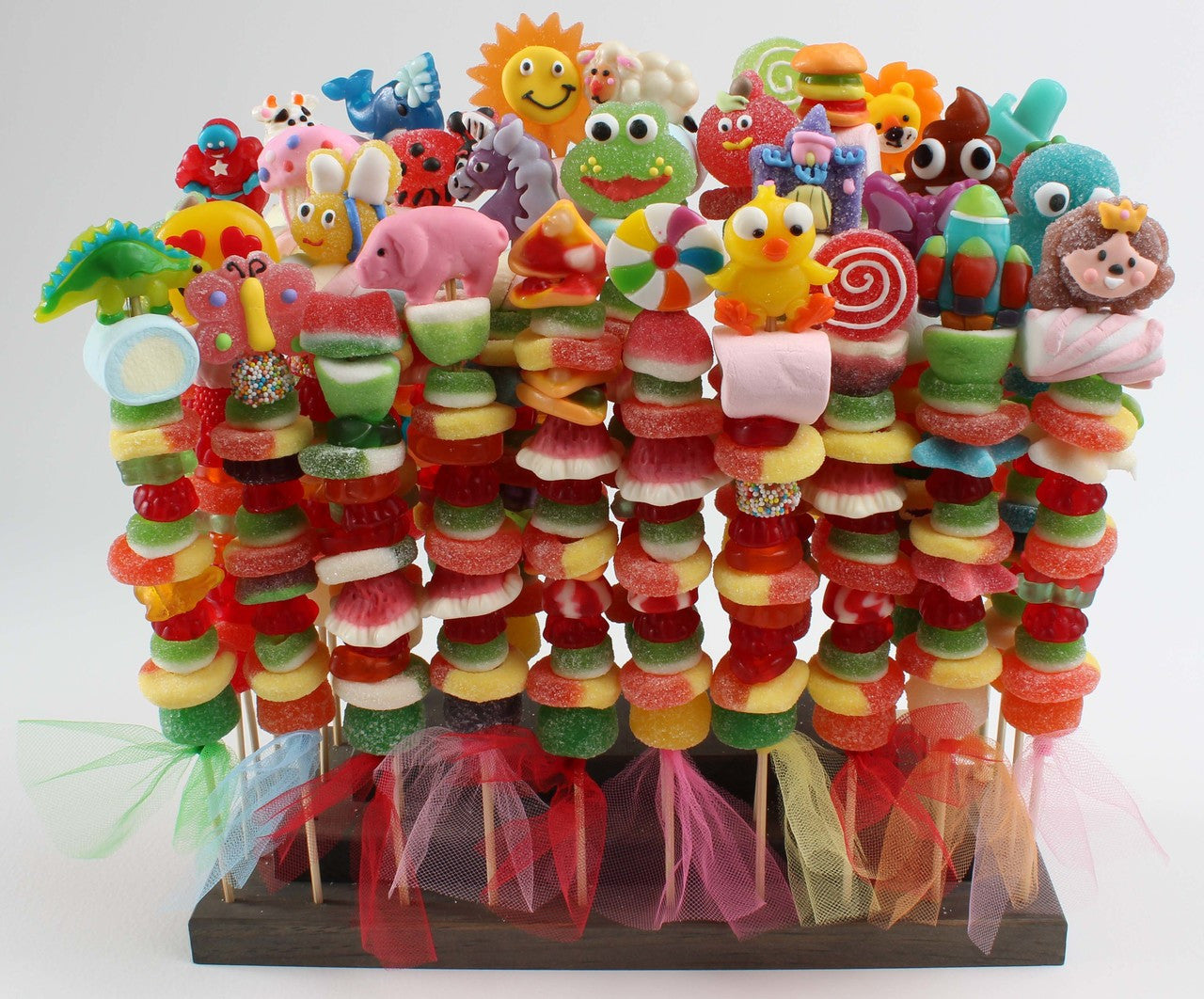 Different types of gummies stacked on skewers to form candy kabobs made for every occasion. 