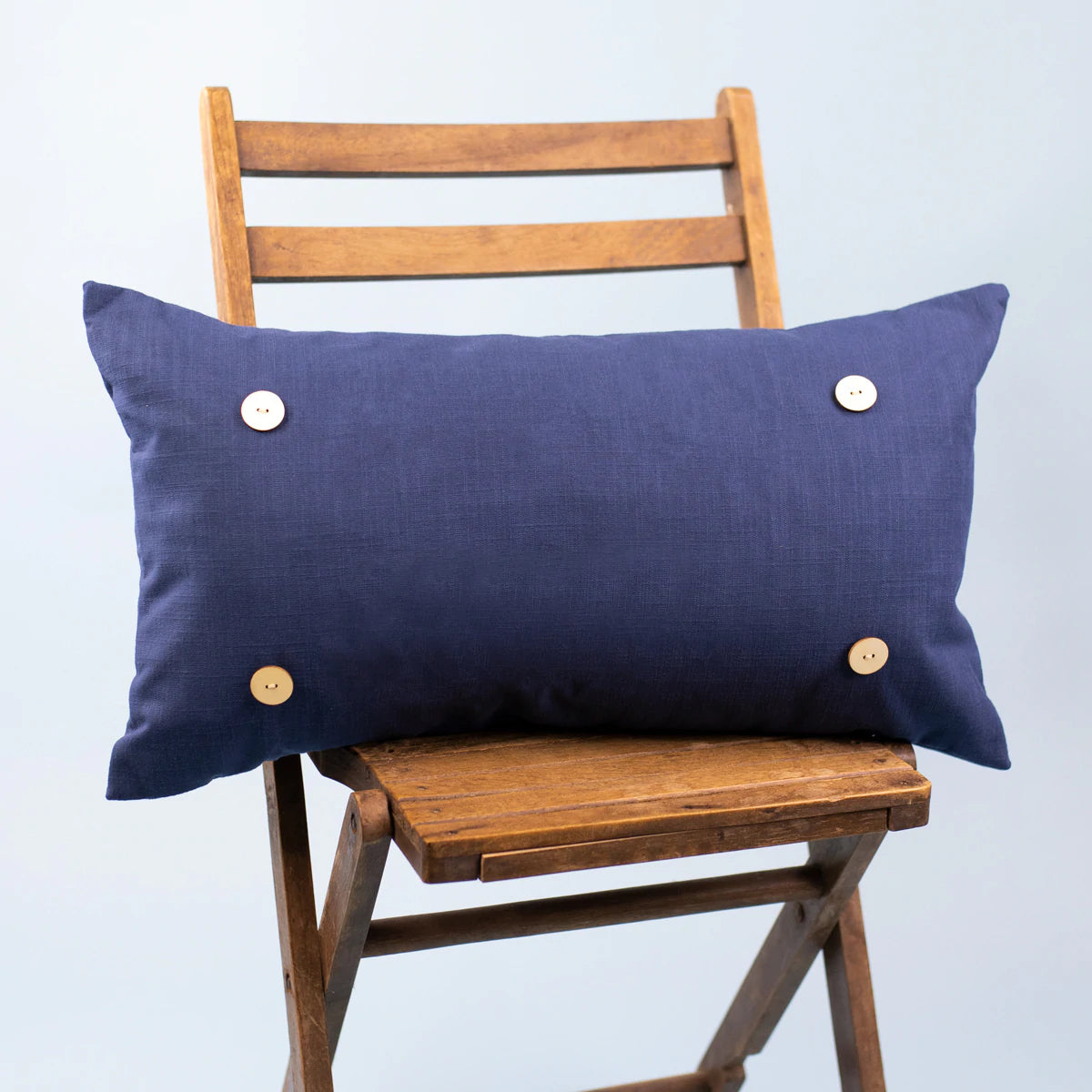 Solid Navy Pillow with Four wooden buttons in each corner to add pillow attachment 