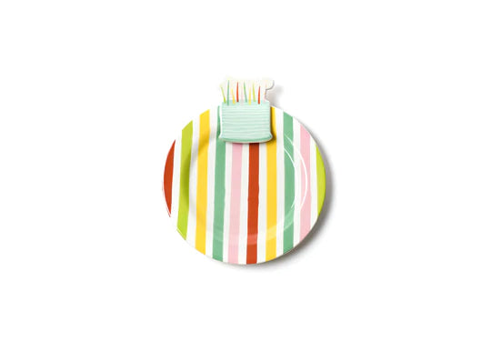 Mini desert serving plate, white base with multi-colored stripes with small ceramic birthday cake at the top of the plate.
