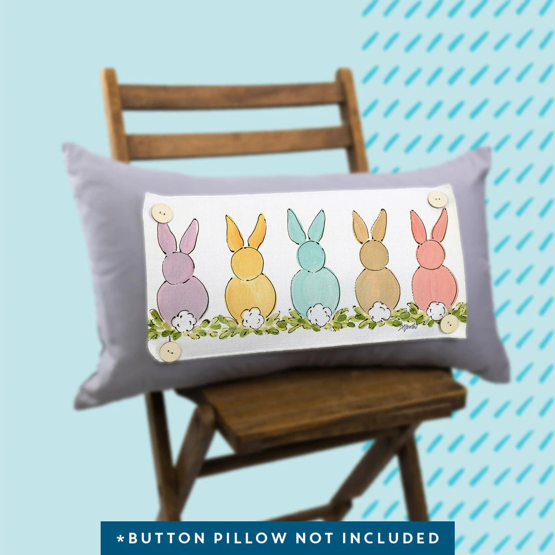 Purple Pillow with Pastel Colored Bunnies Sitting in a Row