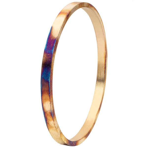 Burnished round gold bangle with purple blue hues.