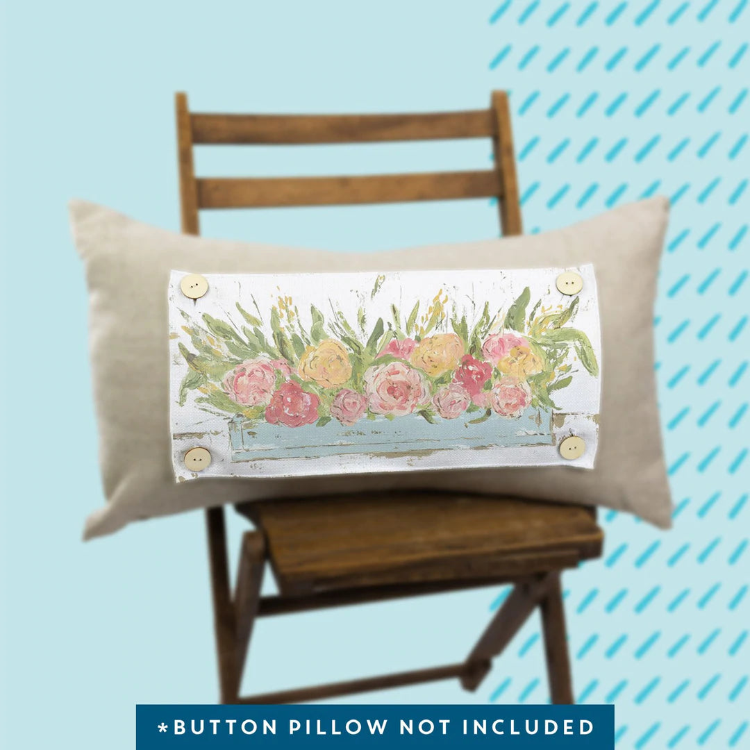 Cream Colored Pillow with Pastel Wooden Flower Pot Full of Pink Flowers