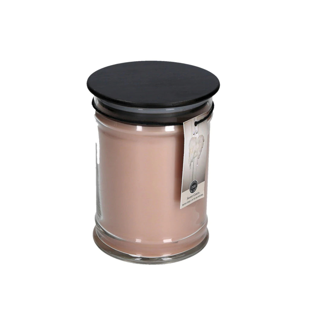 Large jar candle, in the scent of Sweet Grace, light pink wax color.